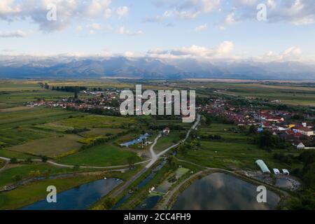 Luftaufnahme des Dorfes Carta mit den Fgaras Bergen im Hintergrund, Siebenbürgen, Rumänien. Stockfoto