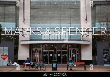 Leicester, Leicestershire, Großbritannien. August 2020. Männer sitzen vor einem Marks and Spencer Store. Marks & Spencer kürzen 7,000 Arbeitsplätze in seinen Filialen und erklären, dass die Òthe-Coronavirus-Pandemie deutlich gemacht habe, dass es in tradeÓ eine materielle Verschiebung gegeben habe. Credit Darren Staples/Alamy Live News. Stockfoto