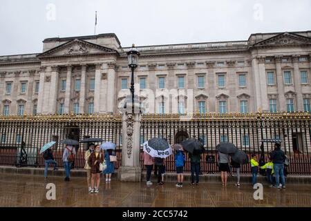 Vor dem Buckingham Palace, London, schützen sich die Menschen vor dem Regen unter Regenschirmen, da viele Teile Großbritanniens vor dem Sturm Ellen, der starke Winde bringen wird, feuchtes Wetter erleben. Stockfoto