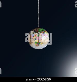 Globe hängt an einem Faden auf dunklem Hintergrund. Unser Konzept für die Rettung von Planeten. Erde im Gleichgewicht. Die Welt ist in Gefahr. Speicherplatz kopieren Stockfoto