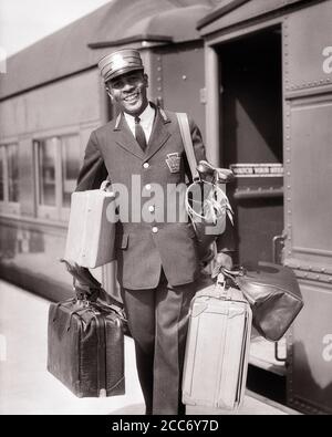 LÄCHELNDER AFROAMERIKANISCHER MANN AUS DEN 1930ER JAHREN, ROTER CAP-PORTIER, DER GEPÄCK HEREINTRÄGT BAHNHOF - R6039 HAR001 HARS ALTE ZEIT BESCHÄFTIGT NOSTALGIE ZÜGE INDUSTRIE ALTE MODE 1 GESICHTSBEHANDLUNG WILLKOMMEN LACHEN KARRIERE EISENBAHN KOFFER FREUDE LIFESTYLE ZUFRIEDENHEIT JOBS VEREINIGTE STAATEN KOPIEREN RAUM GANZLÄNGE KÖRPERLICHE FITNESS PERSONEN VEREINIGTE STAATEN VON AMERIKA MÄNNER BERUF VERTRAUEN TRANSPORT AUSDRÜCKE B&W NORDAMERIKA BLICKKONTAKT NORDAMERIKA RAIL SKILL BERUF SKILLS FRÖHLICH KUNDENSERVICE AFROAMERIKANER AFROAMERIKANER KARRIERE SCHWARZE ETHNIZITÄT ARBEIT STOLZ BESCHÄFTIGUNG BERUFE LÄCHELT KONZEPTUELL Stockfoto