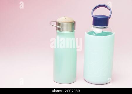 Wiederverwendbare Thermos und Wasserflasche auf einem rosa Hintergrund. Flach Lay lat Design Zero Waste Konzept Stockfoto