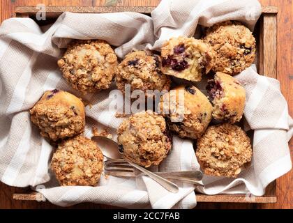 Gemischte Beeren- und Hafermuffins auf einem Holztablett Stockfoto