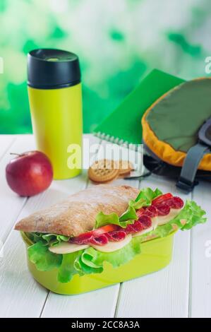 Lunchbox mit Sandwich in der Nähe Thermoskanne und Schulrucksack Stockfoto