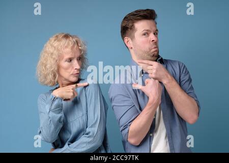 Frau und Mann zeigen sich gegenseitig mit den Fingern an und beschuldigen sich gegenseitig für das Problem Stockfoto