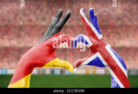 Die Hände eines Menschen bilden ein Herz mit den Flaggen Deutschlands Und Island - Liebe zum Fußball-Konzept Stockfoto