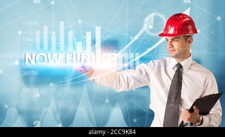 Junger Geschäftsmann mit Helmzeichnung, JETZT MIT Aufschrift, modernes Business-Technologie-Konzept Stockfoto