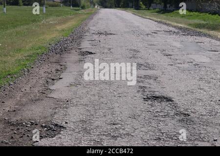 Autobahn mit Löchern auf ukrainischen Straßen, gebrochener Asphalt, Horizontale Ausrichtung Stockfoto