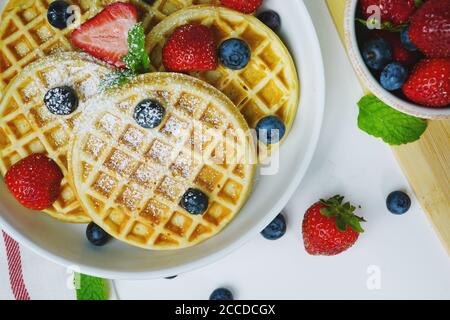 Hausgemachte Mini-Waffeln gekrönt mit frischen Beeren, selektive Fokus Stockfoto