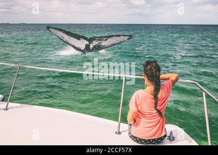 Whale Watching Bootstour Tourist Frau entspannend Blick auf Buckelrücken brechen flattern Schwanz Reiseziel, Sommerurlaub auf Deck des Katamarans Stockfoto