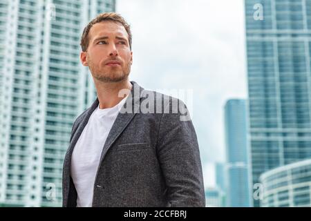 Geschäftsmann junge Mann ernst Porträt tragen smart casual Blazer im Freien Im Hintergrund der Hochhäuser der Stadt Stockfoto