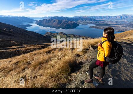 Junge asiatische Reisende Rucksack Wandern auf Roys Peak Track, Wanaka, South Island, Neuseeland Stockfoto