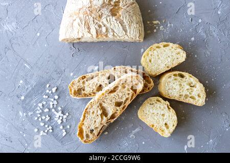 Frisch geschnittenes Brot mit Salz flach legen. Ciabatta Stockfoto