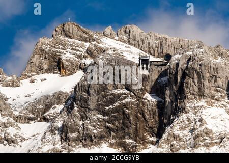 Bergstation der Karwendelbahn im Frühjahr, im Hintergrund die westliche Karwendelspitze und blauer Himmel Stockfoto