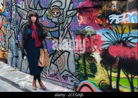 Weibliche Touristen halten an der farbenfrohen Street Art entlang der ACDC Lane in Melbourne, Victoria, Australien. Stockfoto