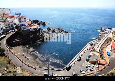 Teneriffa, Kanarische Inseln, Spanien, 21. April 2014 : Urlauber, die im Urlaub die Wintersonne am schwarzen vulkanischen Sandstrand von Puer genießen Stockfoto