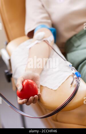 Nahaufnahme der Spenderin, die den Ball in der Hand hält und spendet Blut im Labor Stockfoto