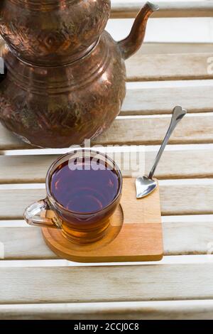 Traditioneller türkischer Tee auf Holztisch mit Vintage-Kupfer-Teekanne Stockfoto