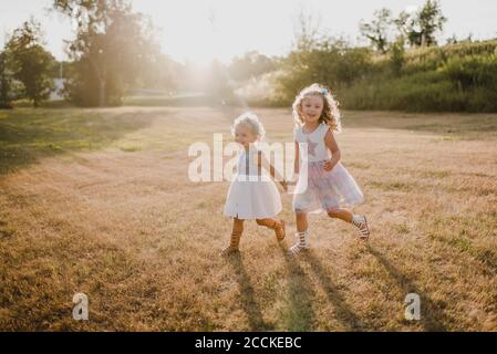 Glückliche Mädchen auf einer Wiese im Gegenlicht Stockfoto