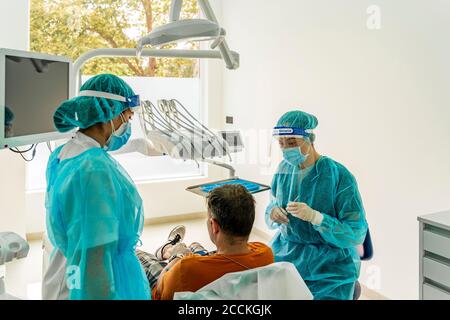 Arzt und Krankenschwester im Gespräch mit dem Patienten in der Zahnklinik Stockfoto