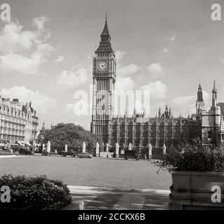 1950er Jahre, historischer Blick aus dieser Zeit über das offene Grün des Parliament Square zum Uhrenturm am nordwestlichen Ende des Palastes von Westminster, dem Sitz des britischen Parlaments, des Unterhauses und des Oberhauses, Westminster, London, England, Großbritannien. Der Platz wurde erstmals 1868 angelegt und verfügte über die ersten Londoner Verkehrszeichen. Der Architekt war Sir Charles Barry. Stockfoto