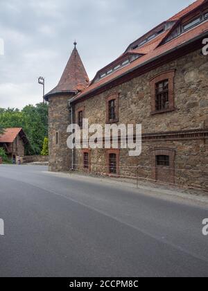 Czocha, Polen-22. Juli 2019: Blick auf die Außengebäude der Burg Czocha von der Straße, die zum Haupteingang führt. Teil von bailey. Stockfoto