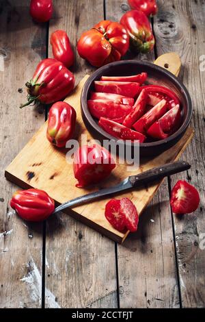 Frische Tomaten für Tomatensauce auf einem Holzschneidebrett. Stockfoto