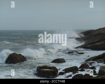 Starke Wellen von den Winden gewellt, brechen hart auf den Felsen des Kaps von Santa Marta.. Stockfoto