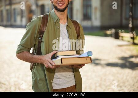 Männlicher Student mit einem strahlenden Lächeln im Freien stehend Stockfoto