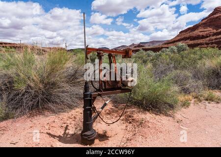 Ein flacher Ölbrunnen mit einem sehr kleinen Pumpenheber im Südosten Utahs. Stockfoto