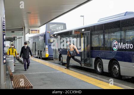 Auckland, Neuseeland. August 2020. Menschen, die Gesichtsmasken tragen, werden an einem Busbahnhof in Auckland, Neuseeland, am 25. August 2020 gesehen. Die COVID-19-Beschränkungen in Neuseelands größter Stadt Auckland werden bis Sonntagabend auf der aktuellen Alarmstufe 3 fortgesetzt, teilte Premierminister Jacinda Ardern am Montag mit. Das Tragen von Masken sei ab Montag auch im öffentlichen Verkehr Pflicht, sagte der Premierminister. Kredit: Li Qiaoqiao/Xinhua/Alamy Live Nachrichten Stockfoto