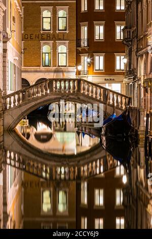 Brücke und geparkte Gondeln, Spiegelungen im Kanal, Venedig, Venetien, Italien Stockfoto