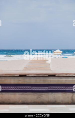 Symbol eines Pfeils auf dem Holzsteg in der Anzeige Der Eingang zum Strand Stockfoto