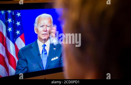 Ein Wähler beobachtet Senator und demokratischer Präsidentschaftskandidat Joe Biden geben seine Dankesrede auf der virtuellen Demokratischen Nationalversammlung am Donnerstag, 20. August 2020. (© Richard B. Levine) Stockfoto