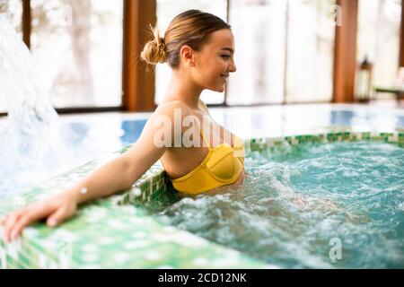 Hübsche junge Frau entspannen im Whirlpool Badewanne Stockfoto