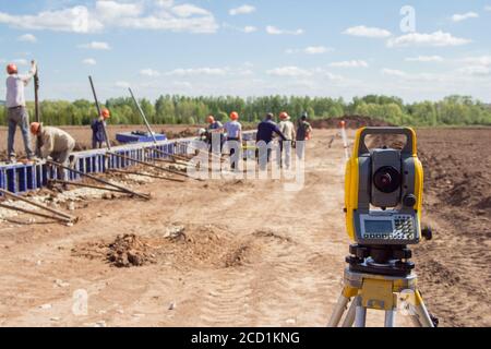 Baumaschinen. Vermesser Ausrüstung Theodolit auf der Baustelle. Überwachung des Fortschritts der Bauarbeiten. Stockfoto