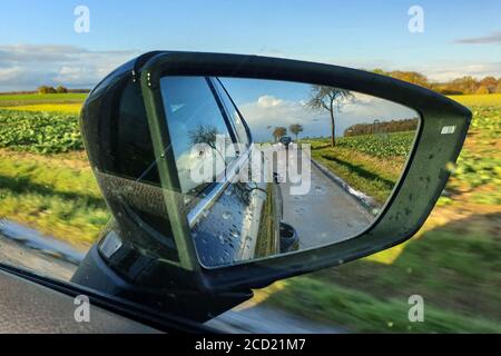Nahaufnahme der Straße im Seitenspiegel Des Fahrzeugs Stockfoto