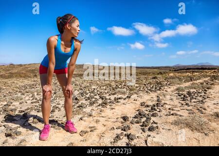 Trailrunner Frau müde Atmung schwer während ultra laufen Cardio-Training erschöpft auf schwierigen Lauf Rennen. Asiatischer junger Athlet im Wüstensommer Stockfoto