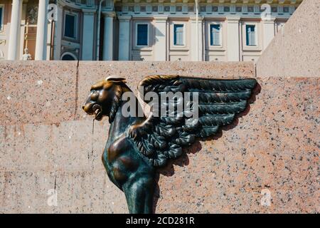 Bronzeskulptur aus Greifen mit goldenem Kopf auf Granitdamm Nahaufnahme Stockfoto