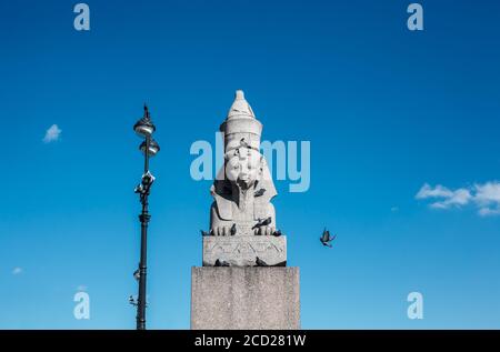 Alte Statue der ägyptischen Sphinx mit geschmiedeten Straßenlaterne gegen Blau Himmel an sonnigen Tagen Stockfoto