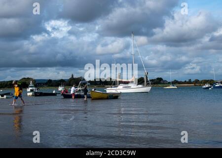 Itschenor Hafen an einem schönen Sommertag in England mit Menschen ziehen ihr Boot an Land. Stockfoto