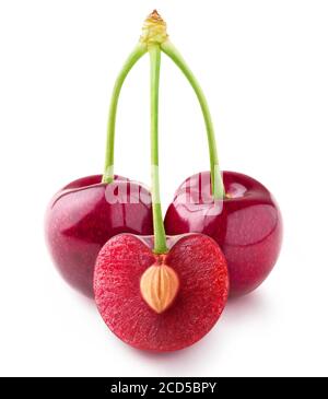 Isolated cherries. Three sweet cherry fruits on one stem, one cut in half with a pit, isolated on white background Stockfoto