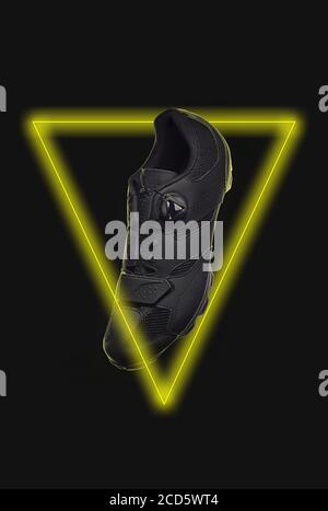 MTB-Schuh in der Mitte des gelben Neonlicht-Dreiecks Abbildung Stockfoto