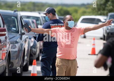 Austin, TX USA 26. August 2020: Dante Ferguson aus Beaumont begrüßt einen Freund in einem Evakuierungszentrum für Bewohner von Huricane Laura an der Küste von Ost-Texas und Südwest-Louisiana. Das Zentrum, auf der Rennstrecke Circuit of the Americas, war schnell mit Hunderten von Autos gefüllt. Laura wird erwartet, dass sie über Nacht als Sturm der Kategorie 4 landet und an der texanischen Küste und im Landesinneren verheerende Schäden anrichtet. Kredit: Bob Daemmrich/Alamy Live Nachrichten Stockfoto