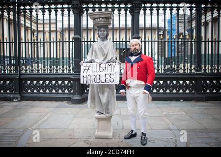 Schauspieler, die als Lord Elgin verkleidet sind, und eine der Parthenon-Skulpturen protestieren vor dem British Museum in London und fordern, dass das Museum die Parthenon-Skulpturen, auch als Elgin Marbles bekannt, nach Griechenland zurückgibt. Stockfoto