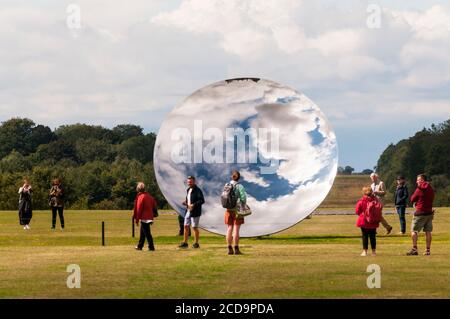 Besucher genießen Sky Mirror von Anish Kapoor auf dem Gelände der Houghton Hall, Norfolk. Edelstahl, 2018. Stockfoto