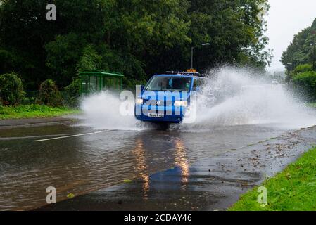 Par, Cornwall, 27/08/2020. Autos sprühen riesige Sprays auf, während sie nach heftigen Regenfällen durch die überfluteten Straßen in Cornwall kämpfen. Stockfoto