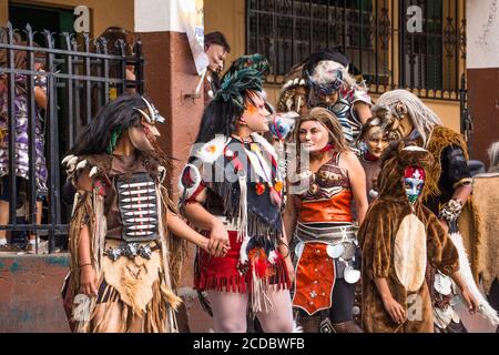Kostümierte Tänzer in Masken treten für das Festival von Santiago auf dem offenen Markt in Santiago Atitlan, Guatemala. In Santiago Atitlan, Guatemala. Stockfoto