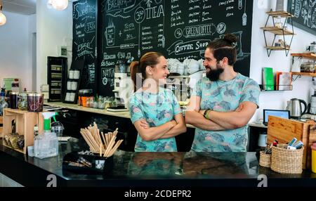 Ein paar Besitzer des Cafés posieren lächelnd Stockfoto
