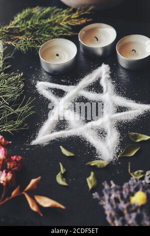 Salz Pentagramm Symbol auf Wiccan Hexenaltar. Handgemachtes Pentagramm für Schutz und Meditation für Hexenritual. Vertikal Stockfoto